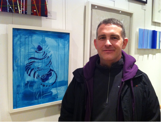 Man standing in front of a painting